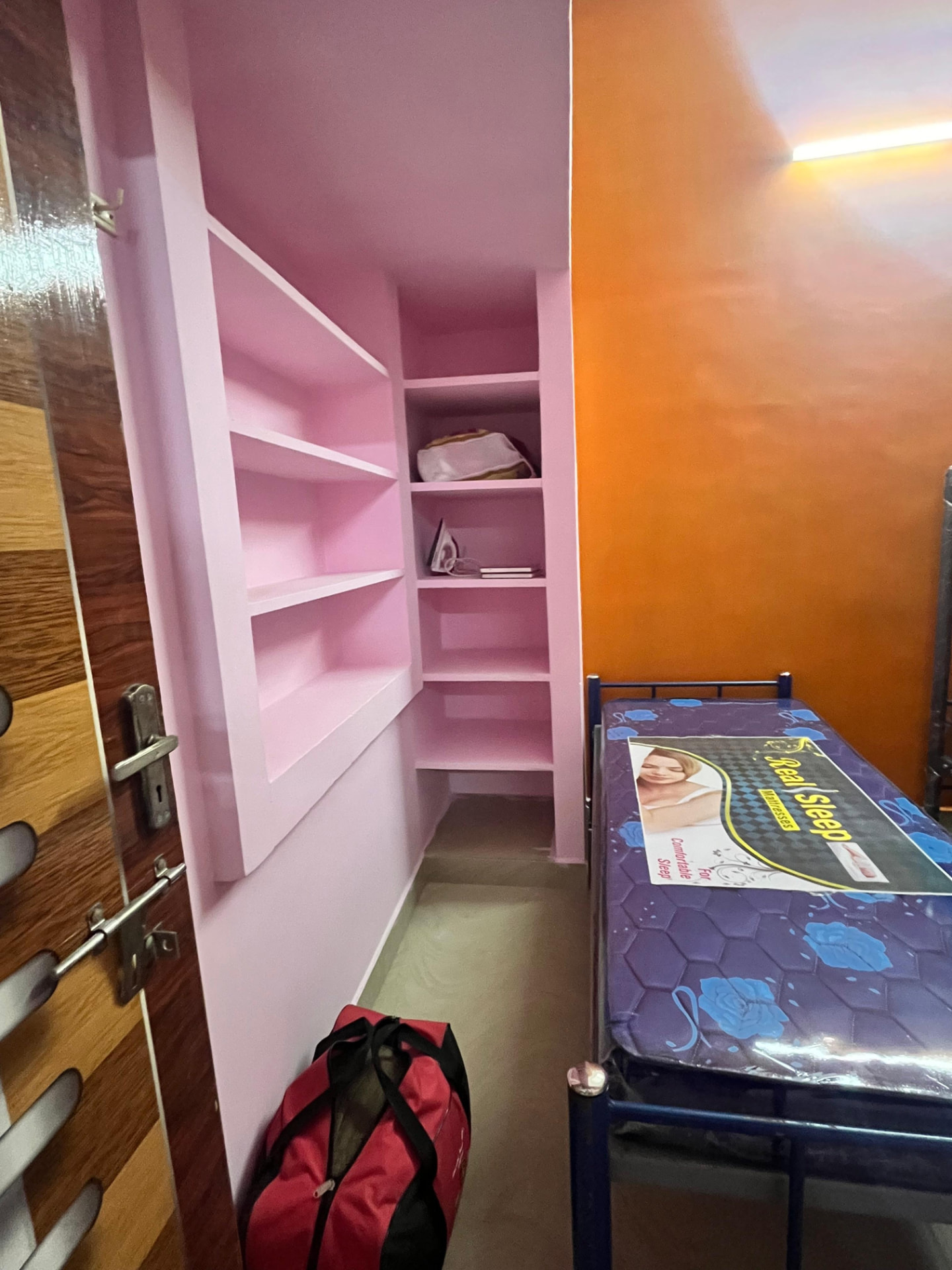 Room with built-in storage shelves at Shree Sai Vishnu PG for Men in Gandhi Nagar